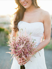 bride holding a bouquet of simple flowers