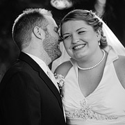 Groom whispering in bride's ear. Black and white photo.