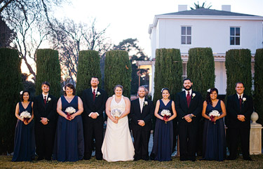 Bridesmaids and groomsmen with the bride and groom on the lawn of Jefferson Street Mansion.