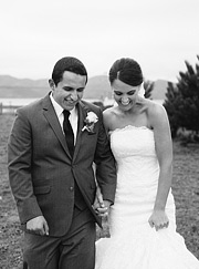 Black and white portrait of bride and groom laughing